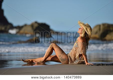 young woman relaxing on the beach in summer day