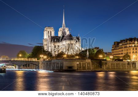 Notre dame de paris cathedral with Seine river at night in Paris France.