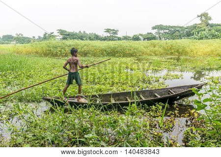 Little Child Is Standing In A Boat