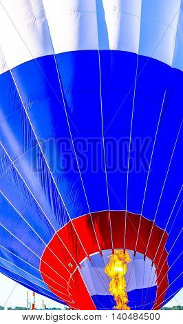 Close up of a hot air balloon getting filled before take off.