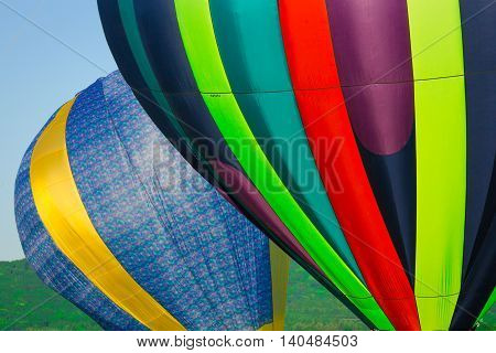 Two hot air balloons getting ready to take off.