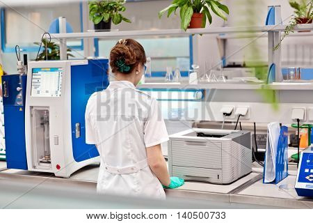 Girl in light well equipped chemestry laboratory