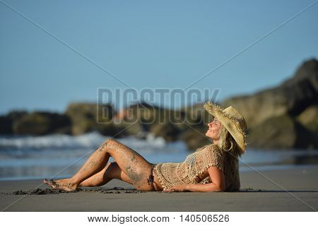 young woman relaxing on the beach in summer day
