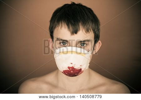 Young Teen Boy Wearing Blood Soaked Surgical Mask