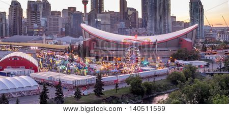 CALGARY, CANADA - JULY 8: Panoramic view of the the Calgary Stampede at sunset on July 8, 2016 in Calgary, Alberta. The Calgary Stampede is often called the greatest outdoor show on Earth.