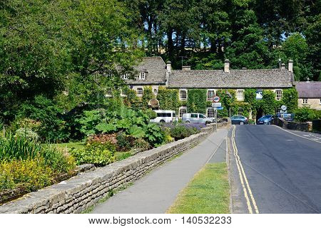 BIBURY, UNITED KINGDOM - JULY 20, 2016 - View towards The Swan Hotel Bibury Cotswolds Gloucestershire England UK Western Europe, July 20, 2016.