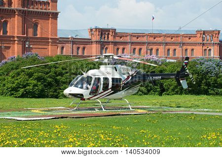SAINT PETERSBURG, RUSSIA - MAY 22, 2016: Helicopter Bell 407GX (RA-01605) on the landing site at the Peter and Paul Fortress. Tourist landmark of the city St. Petersburg