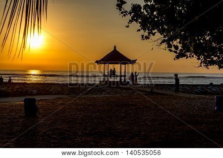 People relaxing after watching a sunrise in Sanur Bali