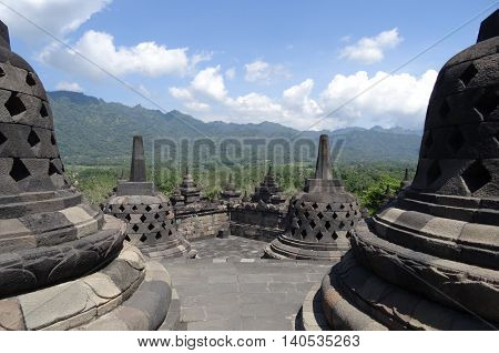 Borobudur Temple Indonesia clear blue sky with hills in the distance