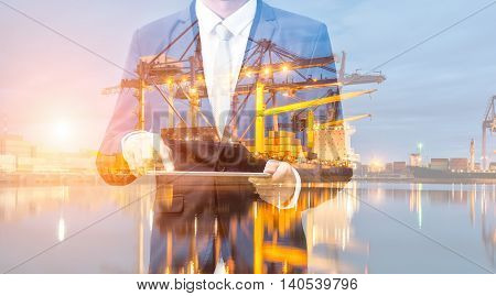 Double Exposure Of Businessman Hand Hold Tablet