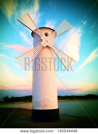 White Windmill By Sea On Rocky Coast. Seascape And Landscape