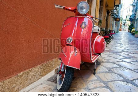CORFU-AUGUST 22: Vespa scooter on Kerkyra street on August 22 2014 on Corfu island. Greece. Vespa is an Italian brand of scooter manufactured by Piaggio.