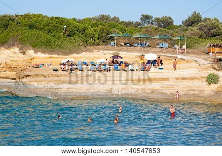 CORFU-AUGUST 26: Sidary beach people sunbath on the sandy shore on August 262014 on Corfu island Greece.