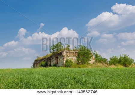 The Ruins Of An Old Building In The Meadow