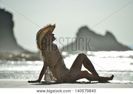 young woman relaxing on the beach in summer day