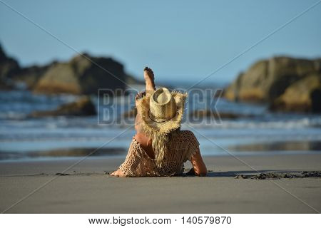 young woman relaxing on the beach in summer day