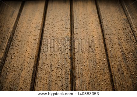 dark brown wood panels after rain with drops
