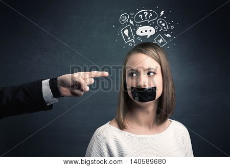 Caucasian business hand pointing at stressed female employee with drawn question, explamation marks above her head