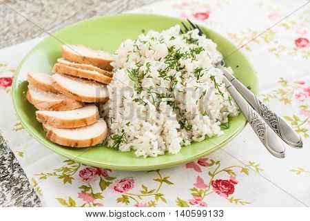 White Rice With Greens And Sliced Pieces Of Meat Grilled On A Green Plate