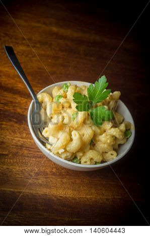 Delicious macaroni and cheddar cheese with parsley sprig