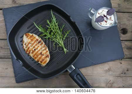 Grilled Chicken Breast Steak With Arugula On Teflon Pan Grill