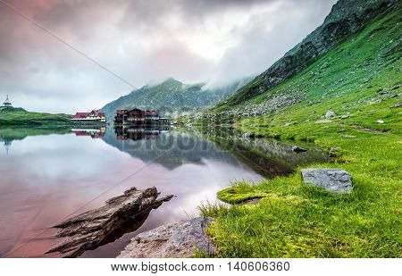 Sunrise at glacial Balea Lac in a foggy morning the Carpathian Mountains Romania