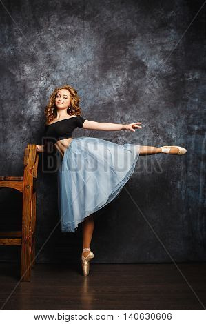 Ballerina Tying Ballet Shoes.Ballet dancer in blue skirt