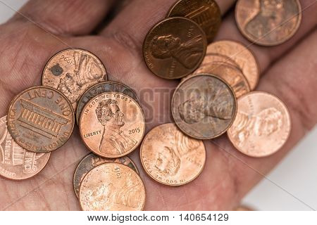 A lot of pennies on a hand