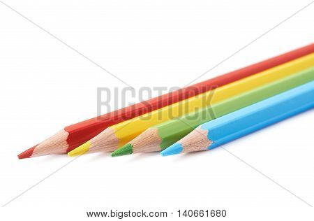 Four colorful drawing pencils composition isolated over the white background, close-up crop fragment