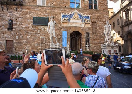 FLORENCE ITALY - JULY 12: Tourists in the Signoria square on July 12 2016