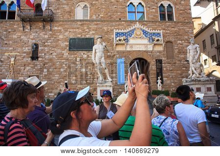 FLORENCE ITALY - JULY 12: Tourists in the Signoria square on July 12 2016