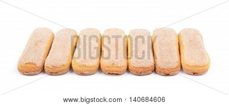 Ladyfinger savoiardi biscuit cookies lined up, composition isolated over the white background