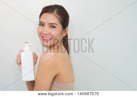 Body Lotion, Portrait Of Beautiful Young Woman Looking At Camera. Beautiful Asian Female Model On Wh