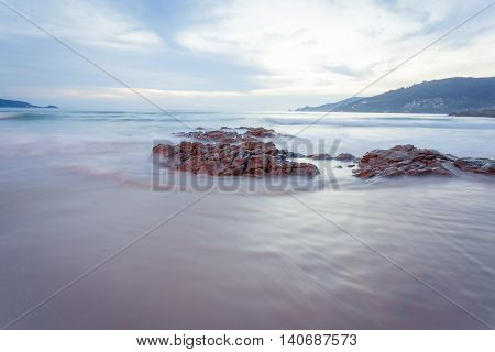 Beautiful sunset at the rock beach at Patong beach Phuket island Thailand