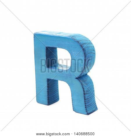 Single sawn wooden letter R symbol coated with paint isolated over the white background