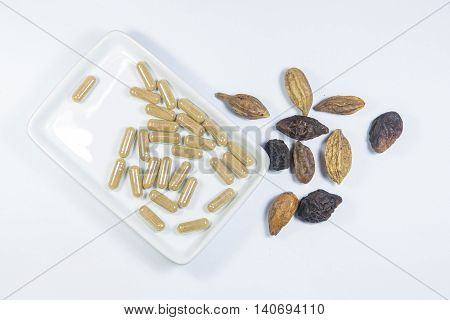 Herb with capsule and thai herb on white dish