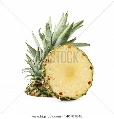 Upper half of a pineapple fruit next to a cross-section slice, composition isolated over the white background