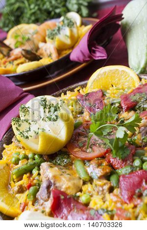 tradirional spanish cuisine paella with mussels and vegetables with starters and wine