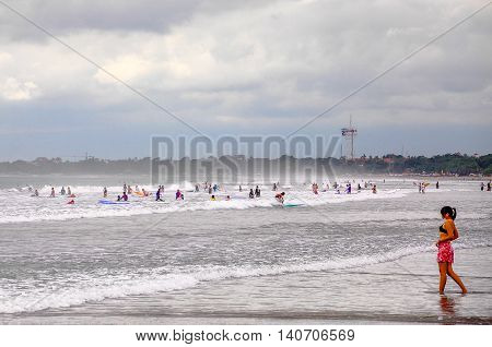 Bali,Indonesia-May 28,2010:People enjoying a fun day at Kuta beach at Bali,Indonesia,also known as Sunset Beach,another name for Sanur Beach.