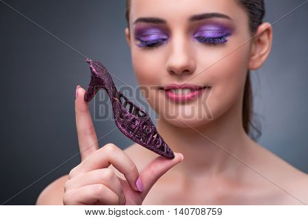 Young woman with purple show in fashion concept