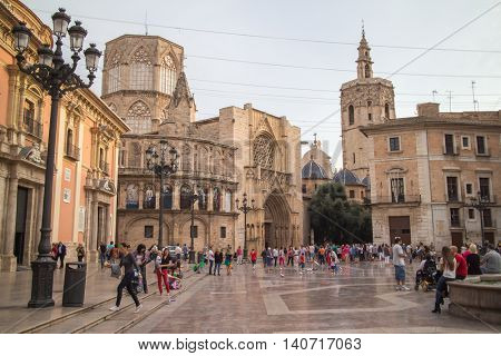 Valencia, Spain - October 19, 2014: Square of Saint Mary's, fountain Rio Turia and Valencia Cathedral in a cloudy day.