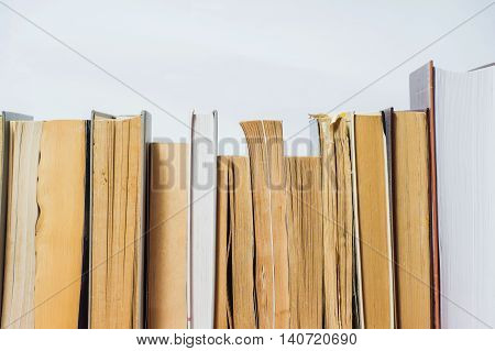 A stack of books in hard and soft cover.