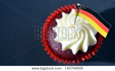 German National Day cupcake with german (black red and yellow) flag. The Day of German Unity. Focus on the flag.