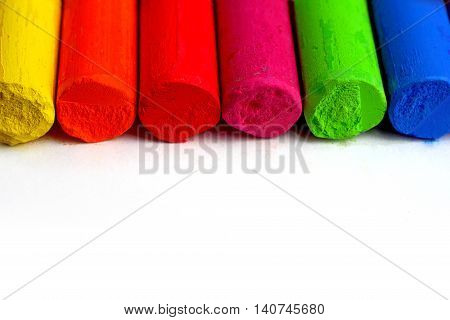 colored crayons on white background macro detail