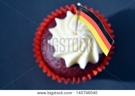 German National Day cupcake with german (black red and yellow) flag. The Day of German Unity. Focus on the flag.