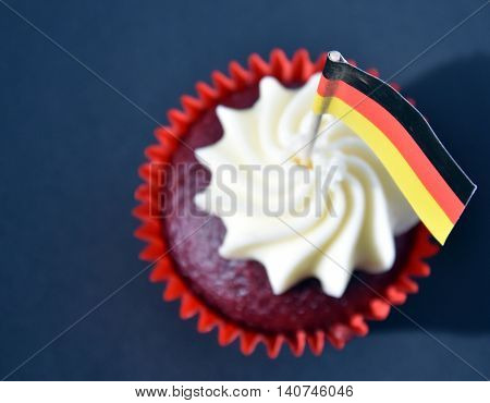 German National Day cupcake with german (black red and yellow) flag. The Day of German Unity. Focus on the flag.