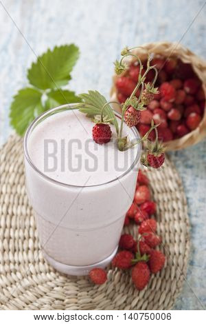 Smoothies with fresh strawberry with yogurt on a wooden table.