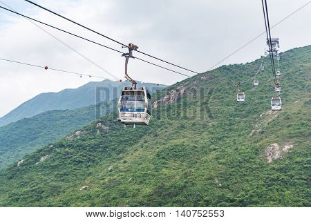 HONG KONG - MAY 26: The Ngong Ping 360 cable cars carry tourists to Ngong Ping village in the cloudy day on May 26 2016 in Hong Kong.