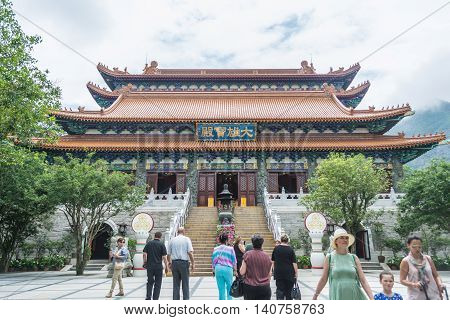 HONG KONG - MAY 26: Tourists walk in front of Hall of Great Hero at Po Lin Monastery on May 26 2016 in Hong Kong.