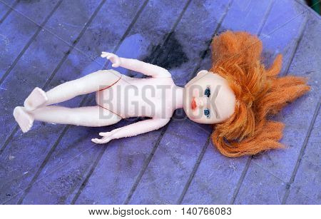 doll thrown in the rain looking for the owner.